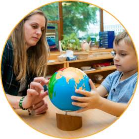 Montessori guide and student in Montessori class during cosmic education lesson