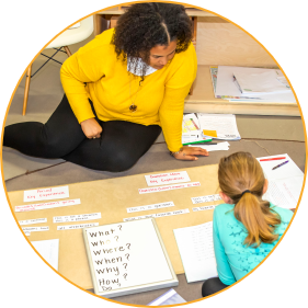 two Montessori guides working with Montessori materials prepared for a language lesson